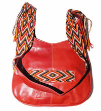 Red leather with red, orange, tan, and black crocheted decoration on a modern Wayuu bag