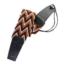 Mustard, maroon, navy, and white colored Wayuu guitar strap. 