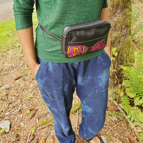 woman wearing the black leather fanny pack/small bag